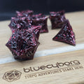 Bloodthorn Crimson Black metal dice set with spiked angular shape, dark red metallic finish and silver numbers