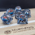 Dragon Eye Prismatic Gaze liquid core resin dice set with smoky clear resin, silver numbers and multicolour dragon eye cores