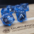 Dragon Siege liquid core resin dice set with blue resin, silver numbers, army silhouette and dragon design