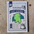 Eldritch Stomp enamel pin badge on BlueCyborg loot card