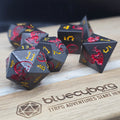 Ember Wyrm black metal dice set with red dragons and gold numbers