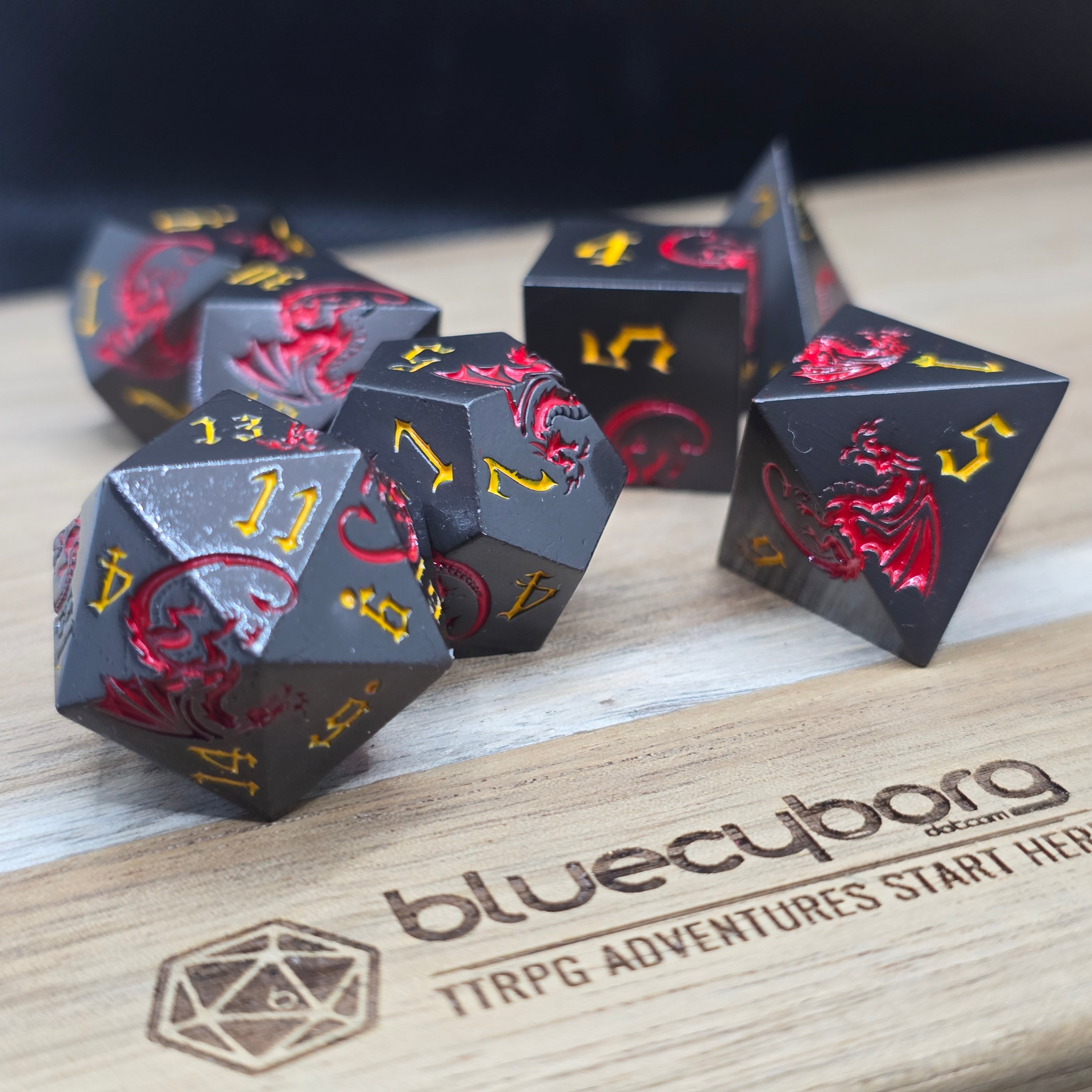 Ember Wyrm black metal dice set with red dragons and gold numbers