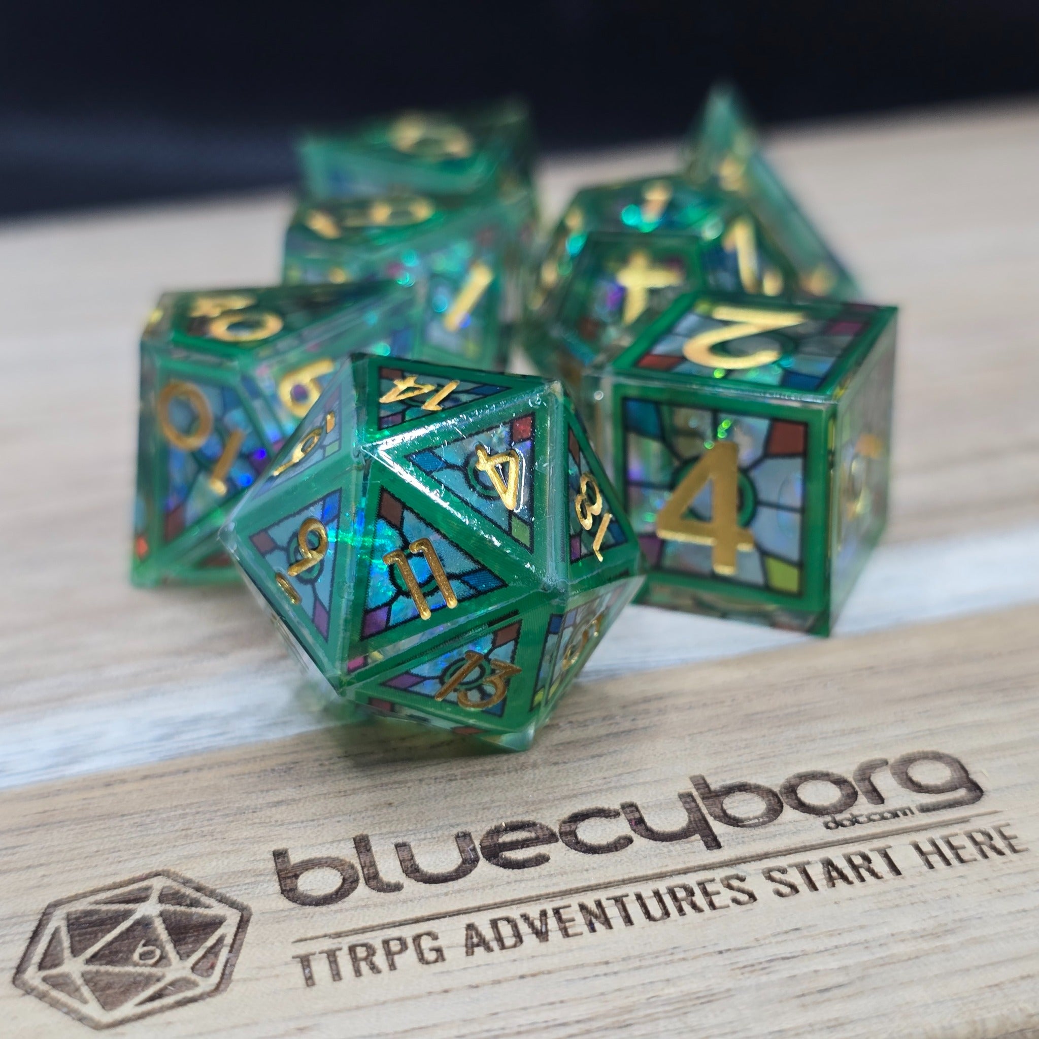 Emerald Shards stained glass style shell resin dice set with green frame, gold numbers and multicoloured shell panels