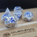 Frost Wyrm Dragon Themed metal dice set with silver finish, blue dragon details and black numbers
