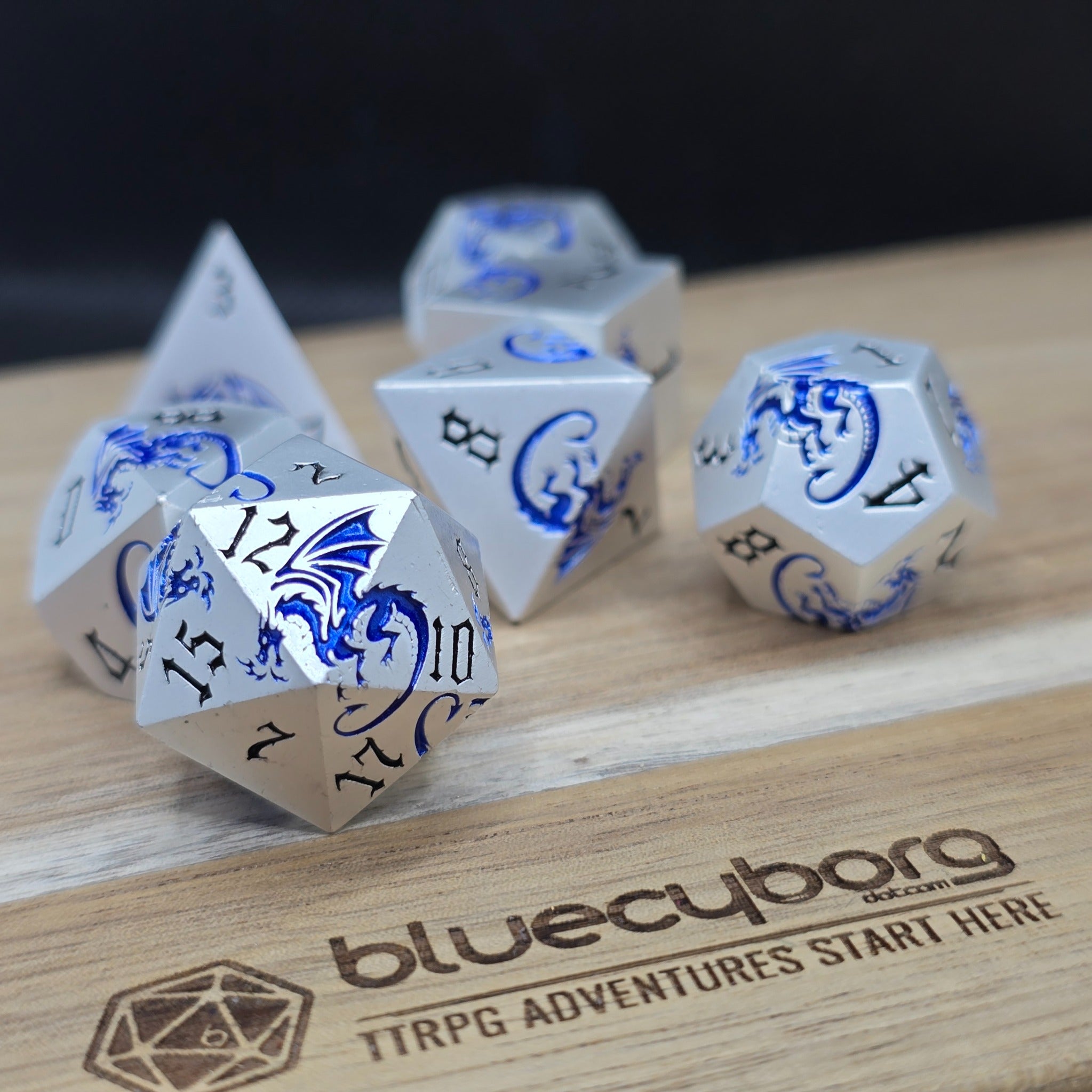 Frost Wyrm Dragon Themed metal dice set with silver finish, blue dragon details and black numbers