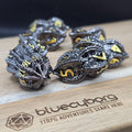 Goblin Peanut Black Gold metal dice set with unusual split-shell shape, gunmetal finish and gold numbers