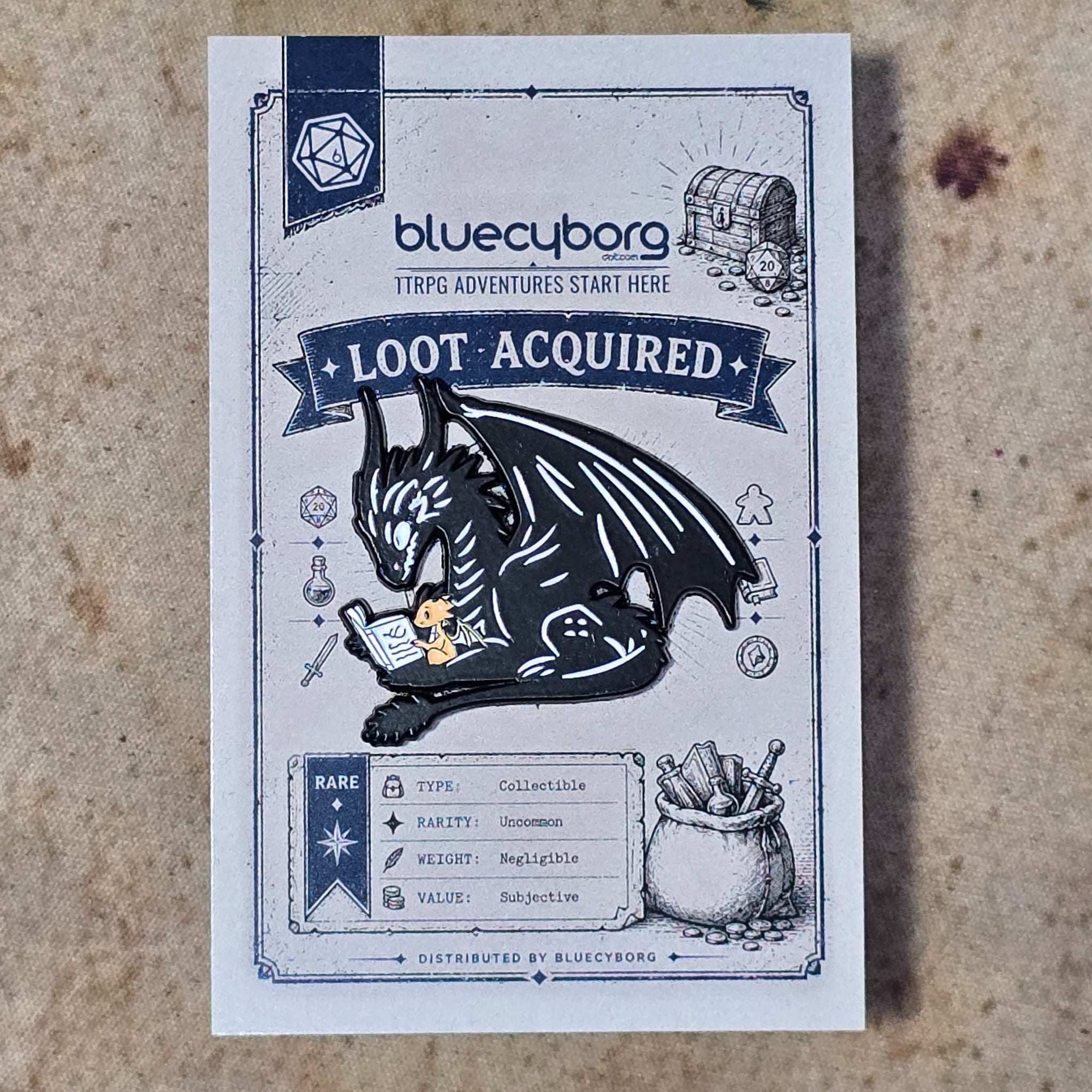 Hoard of Stories Dragon Reader enamel pin badge on BlueCyborg loot card