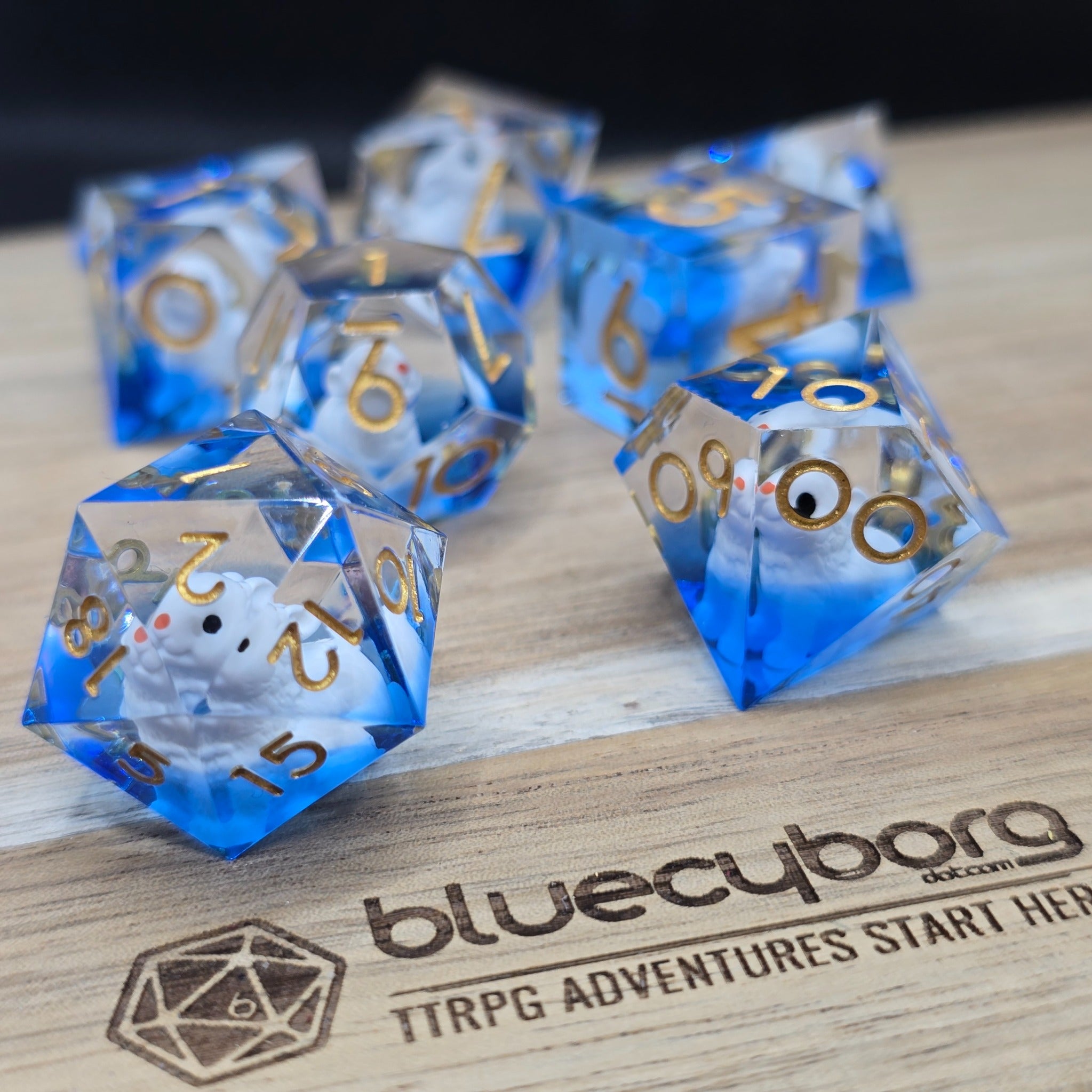 Lucky Rabbit Blue resin dice set with blue clear resin, gold numbers and white rabbit detail