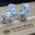 Prismatic Wyrm silver metal dice set with iridescent pink green dragon detailing