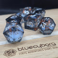 Quicksand Gilded Smoke liquid core resin dice set with smoky resin, silver numbers and gold leaf flecks