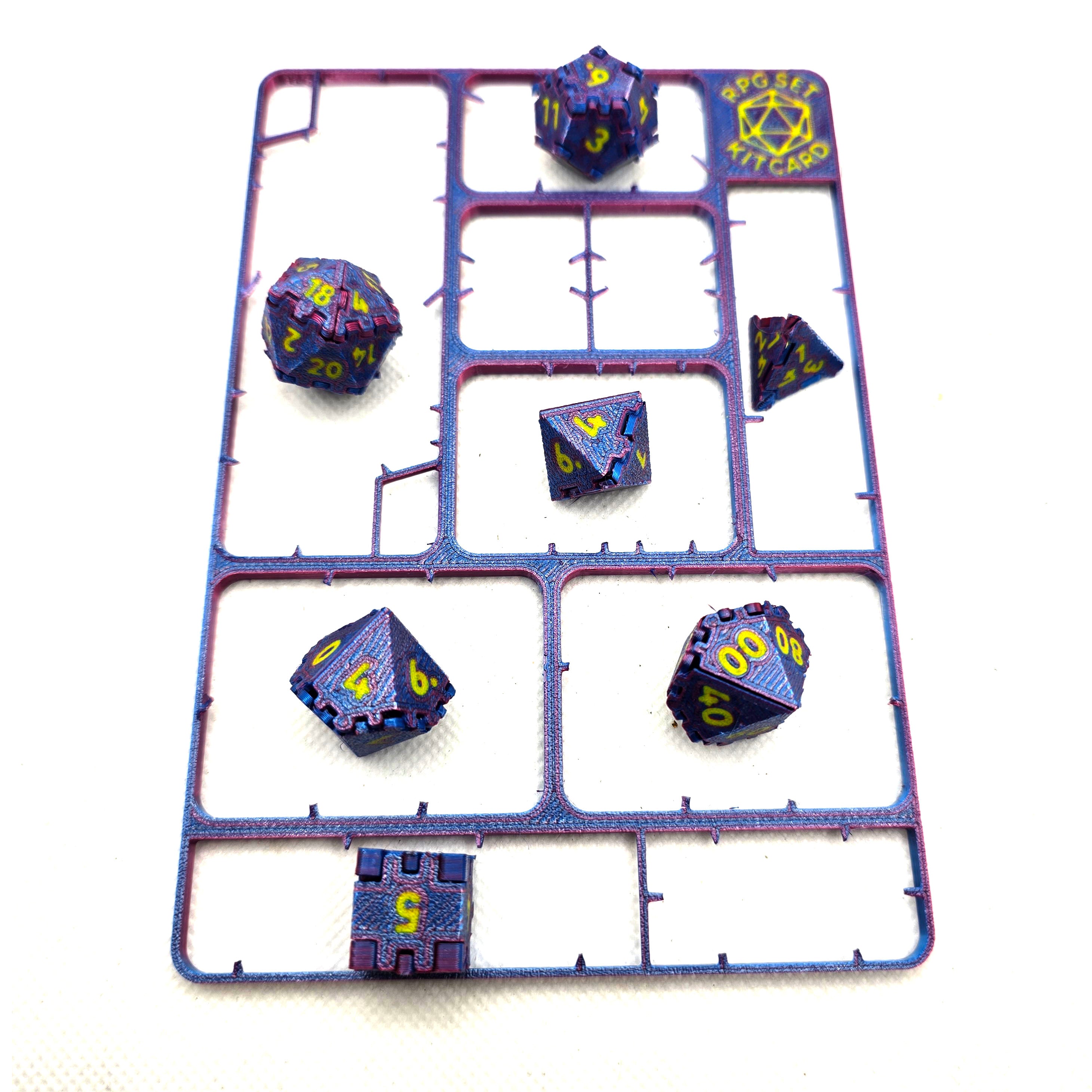 Seven assembled RPG dice displayed on the empty kit card frame