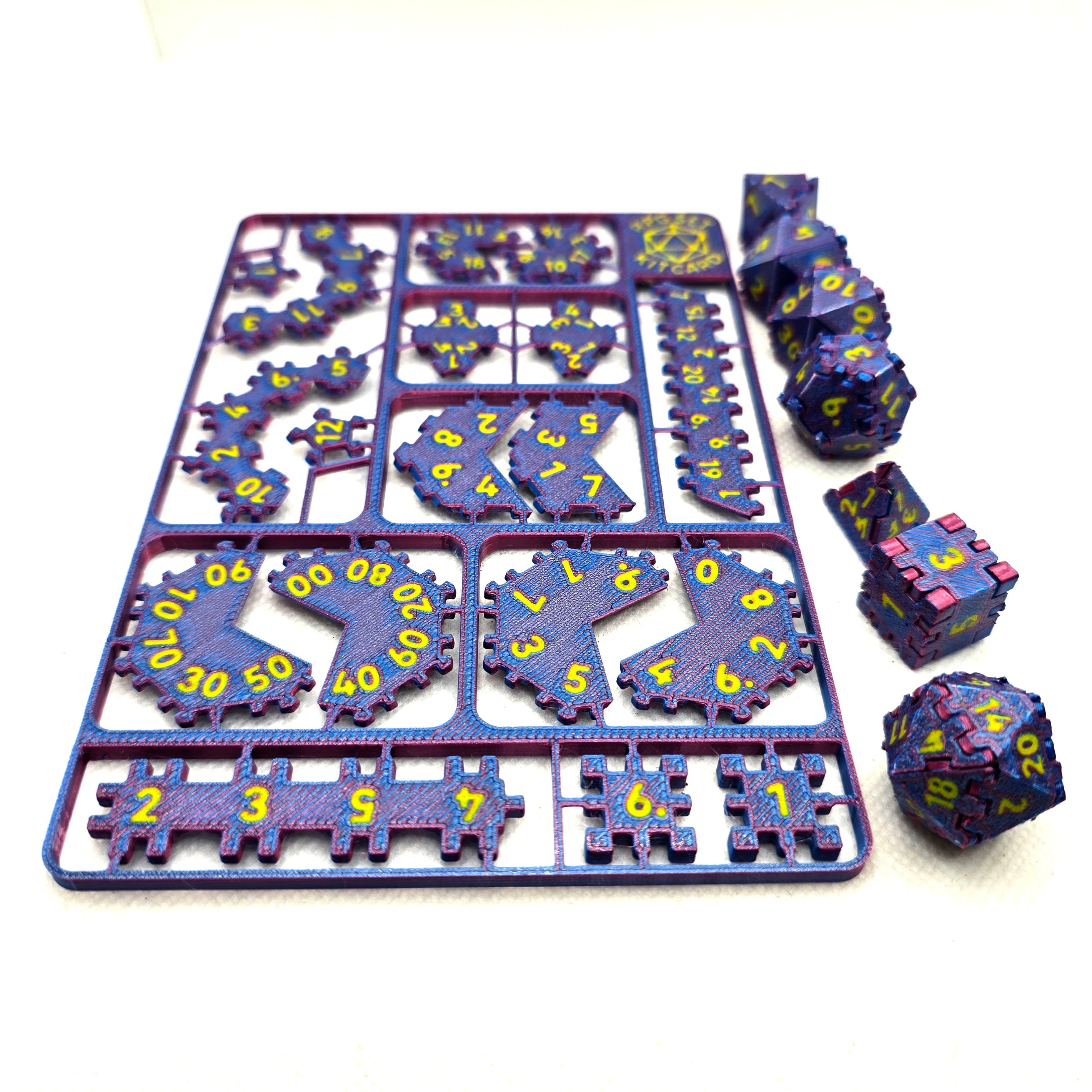 RPG dice kit card pieces beside assembled dice