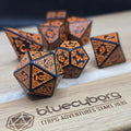 Emberforge Runebound acrylic dice set in black with copper-orange knotwork