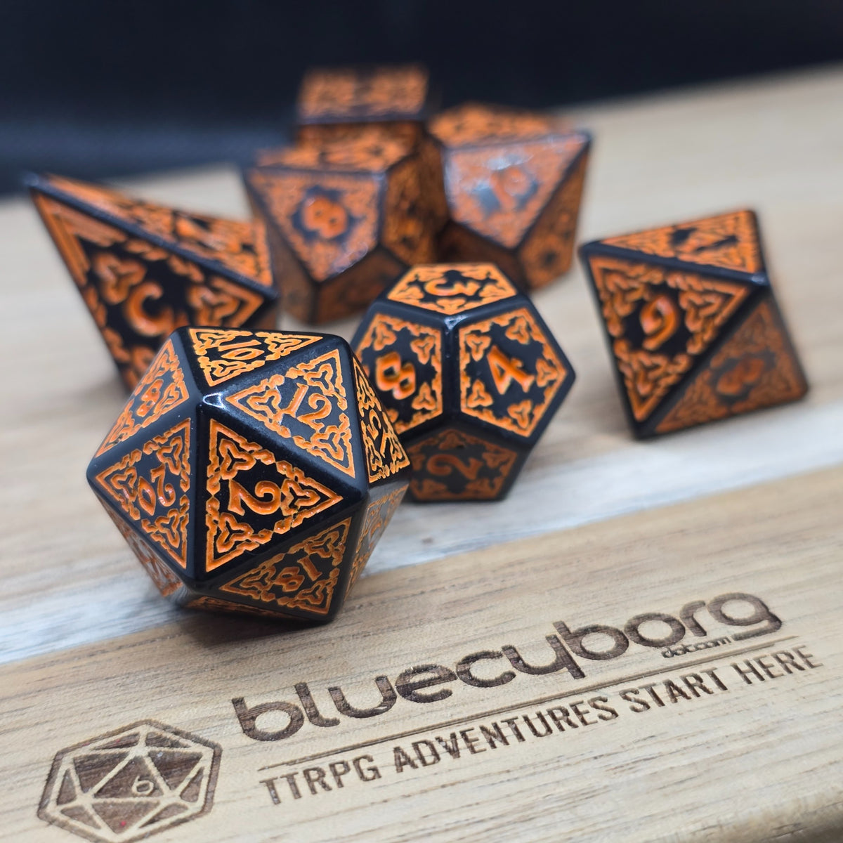 Emberforge Runebound acrylic dice set in black with copper-orange knotwork