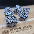 Frostveil Runebound acrylic dice set in black with silver-white knotwork