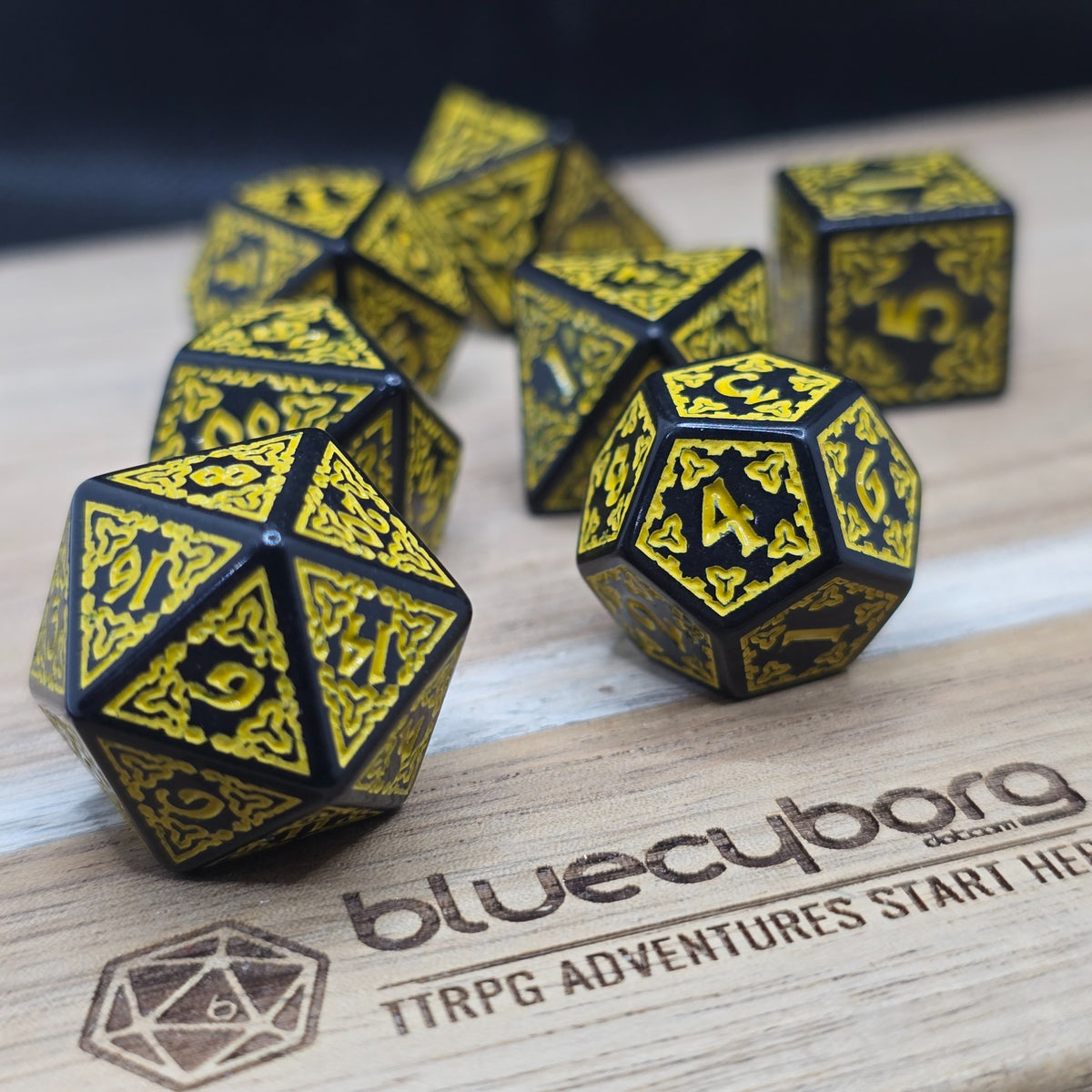 Sunfire Runebound acrylic dice set in black with golden-yellow knotwork