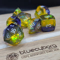 Stormlit Sapphire Jeweller’s Cut resin dice set with blue resin, yellow glow, silver numbers and faceted finish