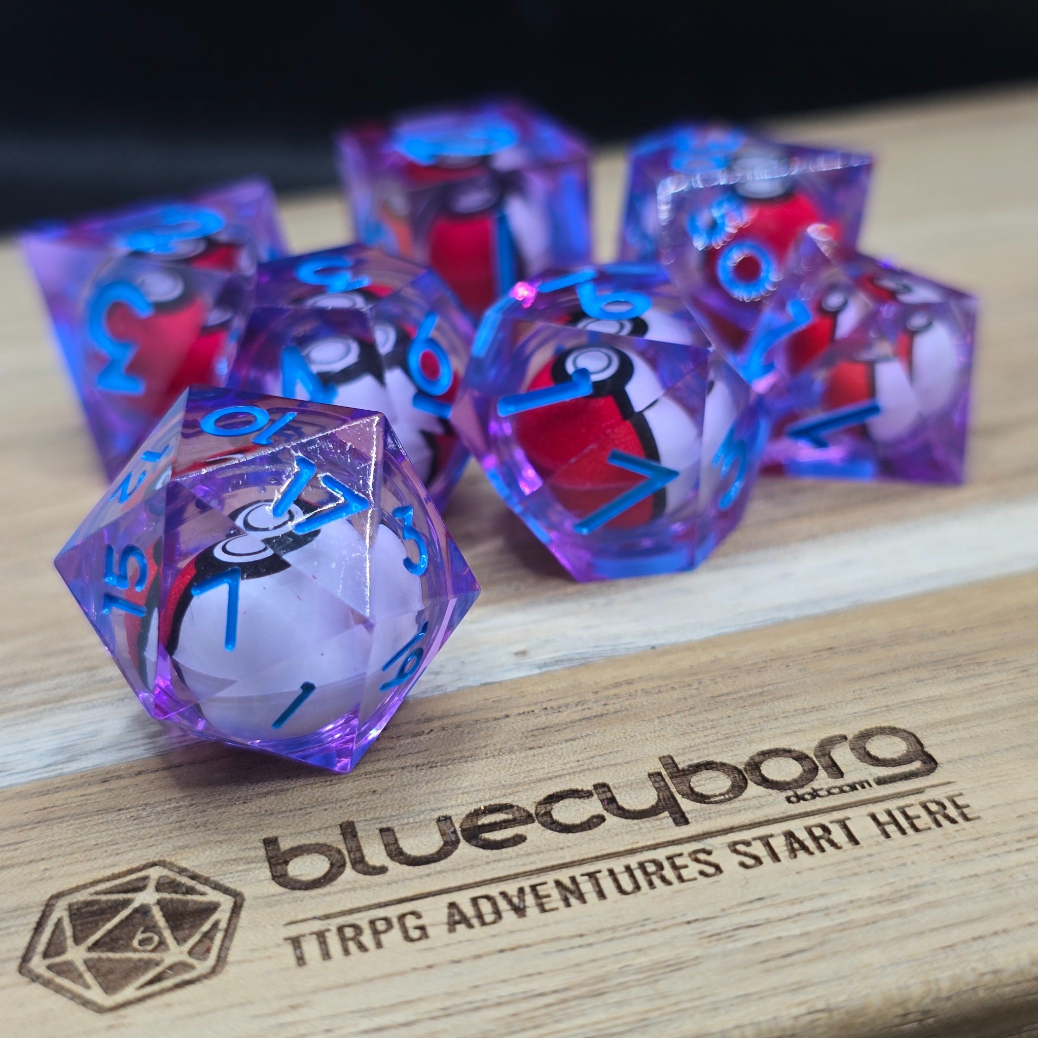Summoner’s Core Blue liquid core resin dice set with blue numbers and red and white summoning core details